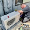 Technician servicing AC unit in Los Angeles home