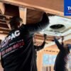 HVAC technician repairing air conditioner at a West Hills CA home in summer