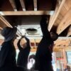 HVAC technician servicing a ductless mini-split on a Studio City hillside home