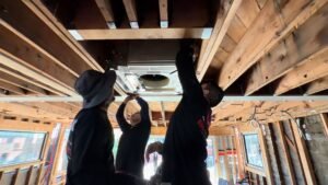 HVAC technician servicing a ductless mini-split on a Studio City hillside home